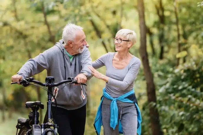 retired couple walking on the community trail