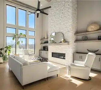 Stylish living room in Woodland Trails with fireplace and large windows